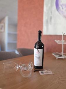 a bottle of wine sitting on a table with glasses at Norra Vilan - Hagalund in Kopparberg +2 photos