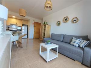 a living room with a blue couch and a table at Charli beach in Miramar