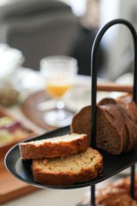 a black plate with bread and a glass of orange juice at Maison d'hôtes Urbegia in Ascain +14 photos