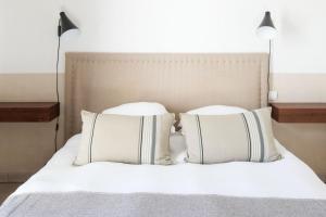 a bed with two pillows on top of it at Maison d'hôtes Urbegia in Ascain