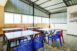 a group of tables and chairs in a room at Hotel Safko Suites in Bangalore