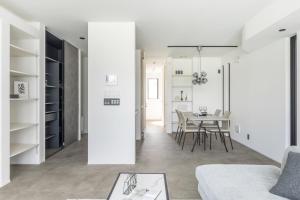 a living room and dining room with a table at Charm Roger Luxury Room 2 in Kamakura