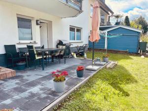 a patio with a table and an umbrella at Mosel mit Herz in Cochem