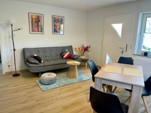 a living room with a couch and a table at Mosel mit Herz in Cochem
