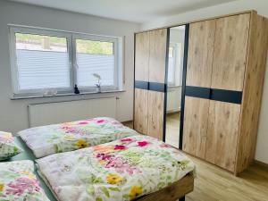 a bedroom with two beds and two windows at Mosel mit Herz in Cochem