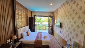 a small bedroom with a bed and a window at MILAN Boutique Garden in Vung Tau +51 photos