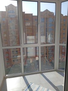 a room with windows looking out at a building at Dolce Vita in Ternopil