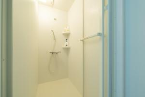 a white bathroom with a shower and a shower at Asahikawa Kawabata House in Asahikawa +47 photos