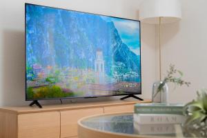 a flat screen tv sitting on top of a cabinet at Asahikawa Kawabata House in Asahikawa
