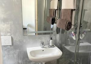 a bathroom with a sink and a mirror at Studio lumineux in La Chaux-de-Fonds