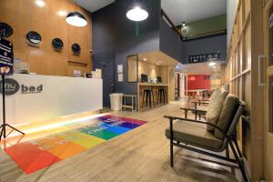 a lobby with a colorful rug on the floor at MyBed Ratchada in Bangkok