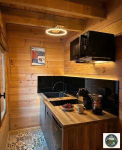 a kitchen with a sink and a counter top at Chalet Lodge - O'Bord de l'Eau in Gérardmer