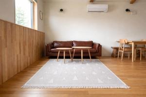 a living room with a couch and a table at mizuki natural villa Garden in Higashikawa +31 photos