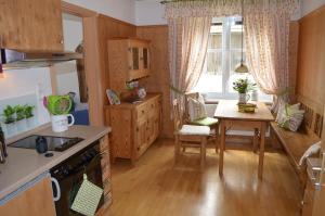 a kitchen with a table and a dining room at Die Dirndlkönigin in Grünenbach