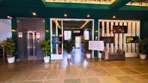 a lobby with potted plants in a building at Haven On Hill - Rishikesh in Rishīkesh