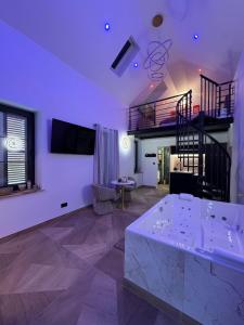 a living room with a staircase and a table at Spa Signature in Dijon