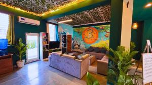 a living room with a couch and a painting on the wall at Haven On Hill - Rishikesh in Rishīkesh