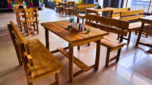 a wooden table and benches in a restaurant at Haven On Hill - Rishikesh in Rishīkesh
