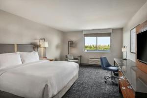a hotel room with a bed and a flat screen tv at Four Points by Sheraton Los Angeles Westside in Los Angeles