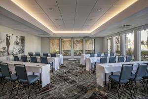 a conference room with white tables and chairs and windows at Four Points by Sheraton Los Angeles Westside in Los Angeles +45 photos