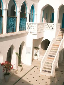 a staircase in a building with potted plants at Al Bait Al Sharqi in Muscat