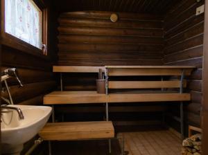 a wooden bathroom with a sink and a sink at Juhantupa in Keuruu