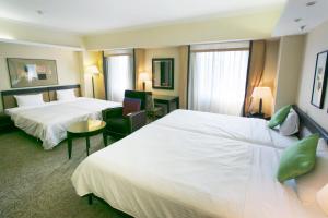 Postel nebo postele na pokoji v ubytování Kanazawa New Grand Hotel Prestige