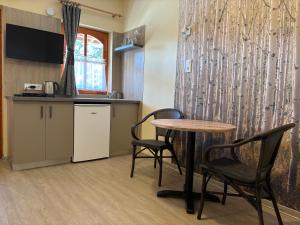 a kitchen with a table and chairs in a room at NAPSUGAR VENDÉGHÁZ in Bogács