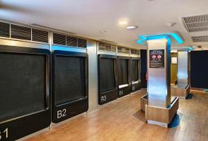 a gym with a row of windows and a machine at MyBed Ratchada in Bangkok