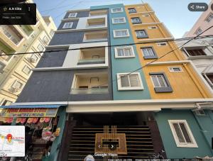 a tall building with a store in front of it at Elite Apartment in Hyderabad