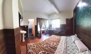 a bedroom with a bed and a desk at Greenview holiday inn in Munnar