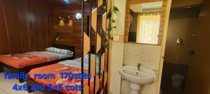 a bathroom with two twin beds and a sink at Greenview holiday inn in Munnar +71 photos