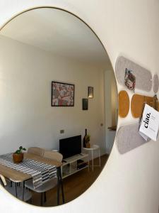 a living room with a table and a mirror at P4 Crema Home in Crema