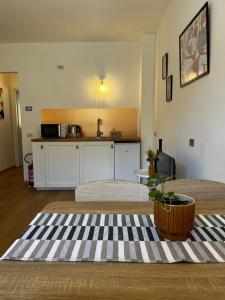 a room with two beds and a kitchen with a table at P4 Crema Home in Crema