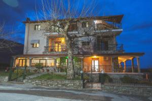 a large house with a tree in front of it at Thermora Hotel in Orma