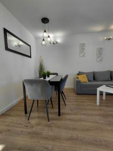 a living room with a table and a couch at Apartments and room Maressa Centar in Vodice