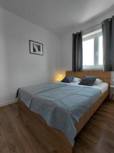 a bedroom with a large bed and a window at Apartments and room Maressa Centar in Vodice