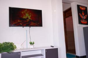 a living room with a tv on a wall at Gessy Homes in Eldoret