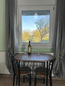 a table with a bottle of wine and two glasses at Akrotiri Studios in Samothraki
