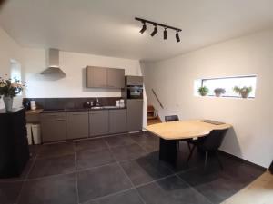 a kitchen with a wooden table in a room at Ferme de la Naverie wi - holiday home for 2 persons in Celles +20 photos