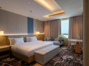 a hotel room with a large bed and a desk at Hills HOTEL - فندق هيلز in Al Khobar +162 photos