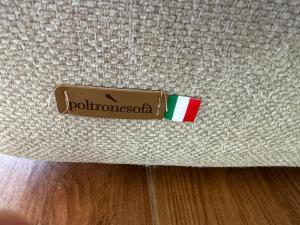 a sign on the side of a couch with the word potomacoat at Vinaka Etna in Biancavilla
