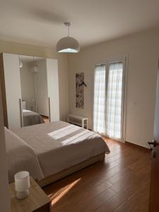 a bedroom with a bed and a large window at Vinaka Etna in Biancavilla +7 photos