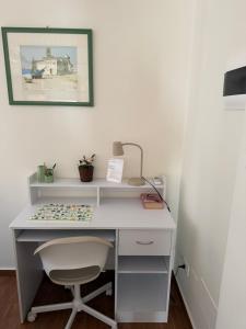 a white desk with a chair in a room at Vinaka Etna in Biancavilla