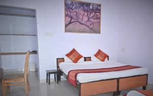 a bedroom with a bed and a picture on the wall at Amar Bagh Ranthambore in Khilchipur +27 photos