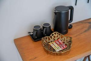a table with a coffee pot and a basket of candy at Uncle Toy in Ban Riang +6 photos