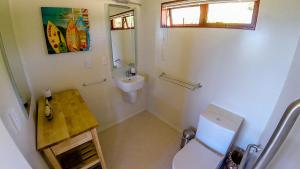 a small bathroom with a toilet and a sink at Sunrise Apartment - Golden Bay in Onekaka