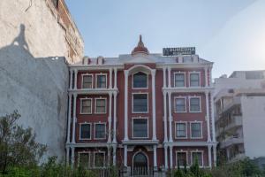a red building with a street sign on it at La Comfort By shrpl in Gurgaon
