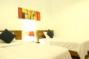 Ліжко або ліжка в номері d'Lumbung Suites and Residence