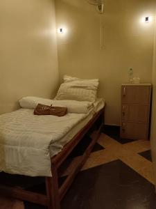 a bed with a bag sitting on top of it at DelMar by Mery World Hospitality in Pattaya South